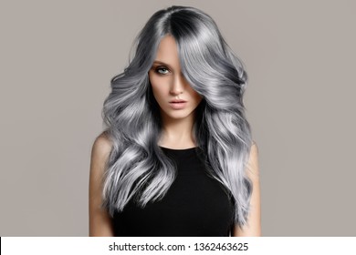 Beautiful Woman With Long Wavy Coloring Hair. Flat Gray Background.