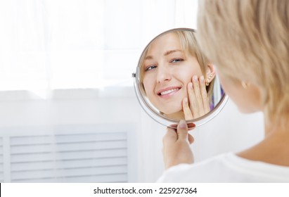 Beautiful Woman Looking In The Mirror In The Morning And Smiling