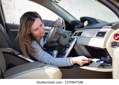 Beautiful Woman Looking For Papers In The Storage Bin At The Passenger Seat.