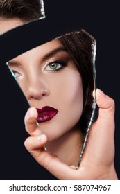 Beautiful Woman Looking In The Piece Of Mirror