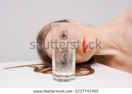 Similar – Image, Stock Photo Blonde woman looks through a window pane with reflections directly into the camera