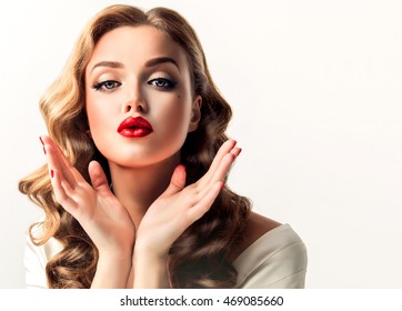 Beautiful Woman  Looks Like A Star Of A Retro Movie . Vintage Pin-up   Girl  Send Air  Kiss . Model With  Curly Hair And Bright Makeup With Red Lips. Hairstyle After Salon And Beauty Face . 