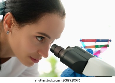 Beautiful Woman Looks Through A Microscope, Profile View