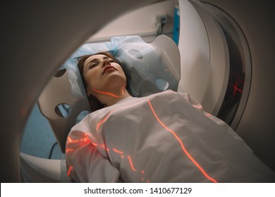 beautiful woman lying on ct scanner bed during tomography test in hospital