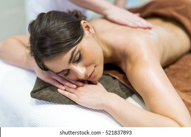 Beautiful Woman Lying On A Massage Table And Relaxing While Being Massaged