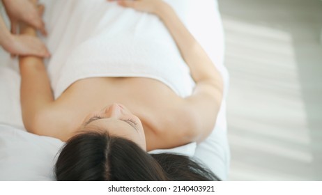 Beautiful Woman Lying On The Spa Bed And Receiving Massage Of Upper Body. Relaxation And Revitalization Of Muscles After Work. Therapist Massage At Arm. Healthy Lifestyle And Body Concept