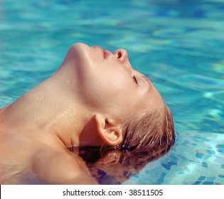 Beautiful Woman Lying In Water Pool