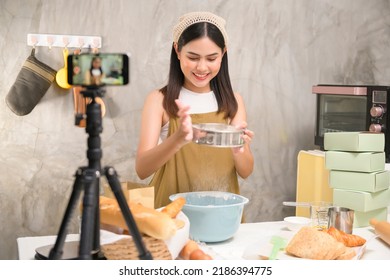 A Beautiful Woman Is Making Bakery While Live Streaming Or Recording Video On Social Media In Her House, Coffee Shop Business Concept. 