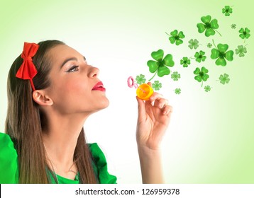 Beautiful Woman Making Four Leaf Clover Bubbles