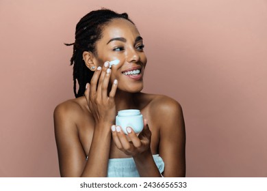 Beautiful woman making skin and facial beauty treatments. Studio shot with focus on cosmetic and skin care concepts - Powered by Shutterstock