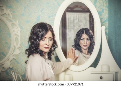 Beautiful woman in the mirror reflected the smiles magically in retro interior