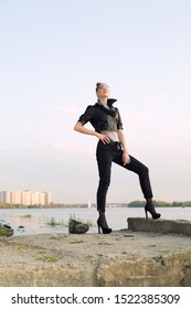 Beautiful woman model in a leather jacket, on the background of the river and the city. - Shutterstock ID 1522385309