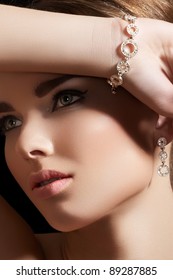 Beautiful Woman Model In Retro Style Make-up. Accessories, Jewelry Gold Bracelet And Earrings With Diamonds. Chic Makeup And Luxury Jewellery