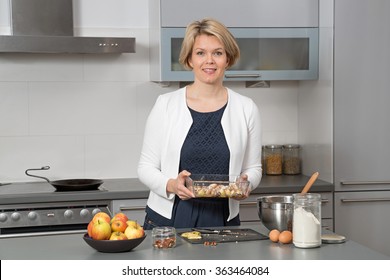 Beautiful Woman In A Modern Kitchen, Baking An Apple Pie