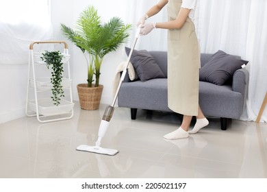 Beautiful Woman Mopping The Floor Of Her Living Room, Big Cleaning In The House, Removes Germs And Dirt And Deep Stains, Housewife Cleaning, Keeping Her Home Clean, Domestic Hygiene.