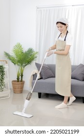 Beautiful Woman Mopping The Floor Of Her Living Room, Big Cleaning In The House, Removes Germs And Dirt And Deep Stains, Housewife Cleaning, Keeping Her Home Clean, Domestic Hygiene.