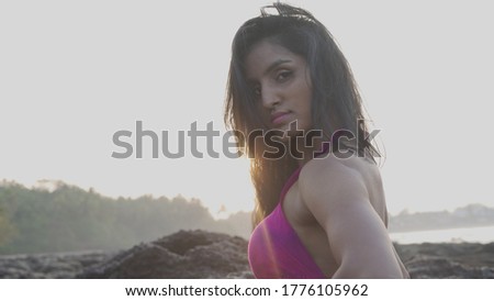 Beautiful woman moving gracefully on the beach