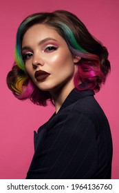 Beautiful woman with multi-colored hair and bright make up and hairstyle.