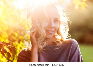 beautiful woman on the background of the setting sun