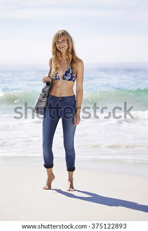 Beautiful woman on beach smiling at camera
