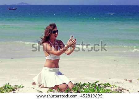 beautiful woman on the beach talking on the phone