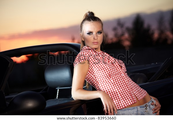 Beautiful woman on black \
cabriolet