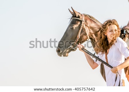 Beautiful woman on a horse. Horseback rider, woman riding horse, sea background