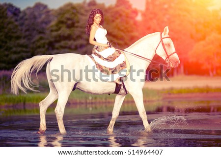 Beautiful woman on a horse. Horseback rider, woman riding horse on beach