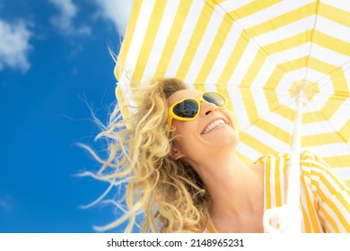 Beautiful woman on summer vacation. Low angle view portrait of happy person against blue sky background.  - Shutterstock ID 2148965231