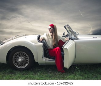 Beautiful Woman On A Vintage Car