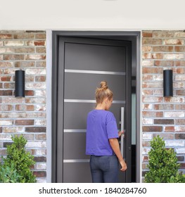 Beautiful Woman Opening The Door Of Her Home.