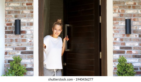 Beautiful Woman Opening The Door Of Her Home.