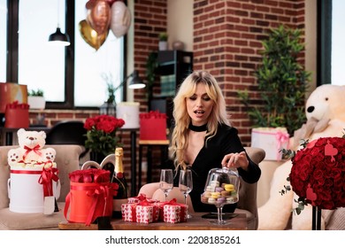 Beautiful Woman Opening Macarons Plate Lid In Living Room With Valentines Day Expensive Gifts, Girl With Luxury Present Boxes, Bear Soft Toy, Roses, Balloons. February 14 Romantic Surprises