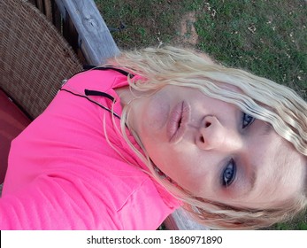 Beautiful Woman Outside Blonde Hair, Blue Eyes. Hot Pink Shirt Very Sexy Lady.  Facial Expression Of Fantasies.  Lips So Soft And Plump.