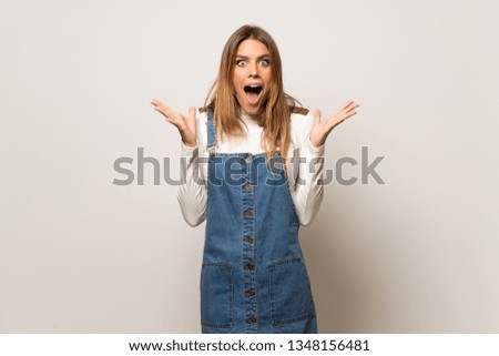 Beautiful woman over isolated white wall with surprise and shocked facial expression