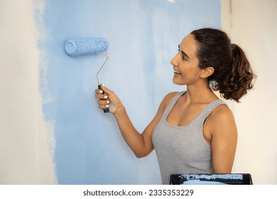 Beautiful woman painting home with smiling. Home renovation DIY renew home concept.  - Powered by Shutterstock