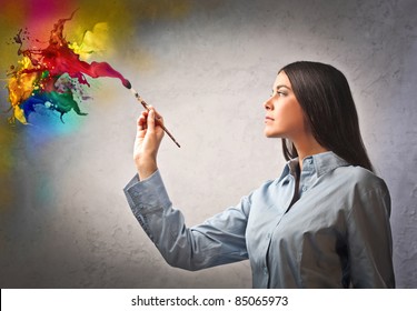 Beautiful woman painting with a paintbrush - Powered by Shutterstock