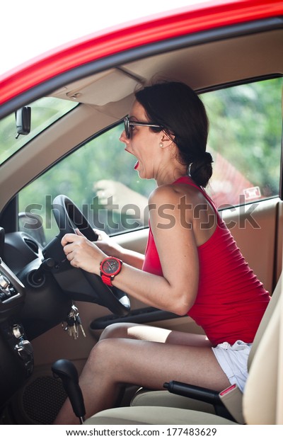 Beautiful woman panic in the\
red car 