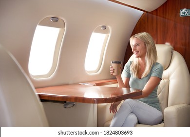 Beautiful Woman With Paper Cup On Plane. Air Travel