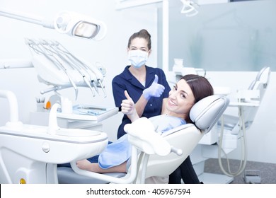 Beautiful Woman Patient Having Dental Treatment At Dentist's Office. Woman Visiting Her Dentist