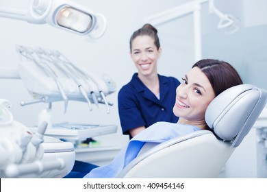 Beautiful Woman Patient Having Dental Treatment At Dentist's Office. Woman Visiting Her Dentist