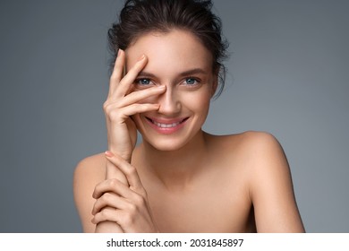 Beautiful woman with perfect skin on gray background. Beauty and skin care concept