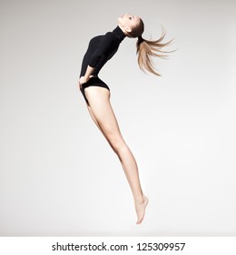 beautiful woman with perfect slim body and long legs jumping - fitness concept