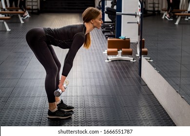 Beautiful Woman Performs Romanian Deadlift In Gym