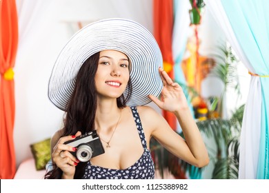 Beautiful woman Photographer making pictures with retro hipster camera having fun at the vacation. Summer lifestyle - Powered by Shutterstock