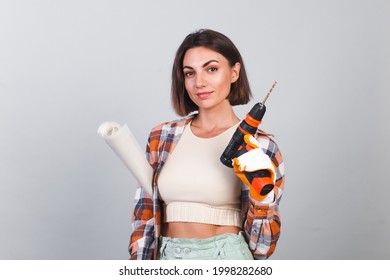 Beautiful Woman In Plaid Shirt On Gray Background Holds Drill To Repair  Home Confident Happy Smile