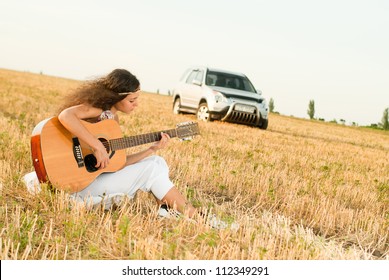 Beautiful Woman Playing Gitar On The Field