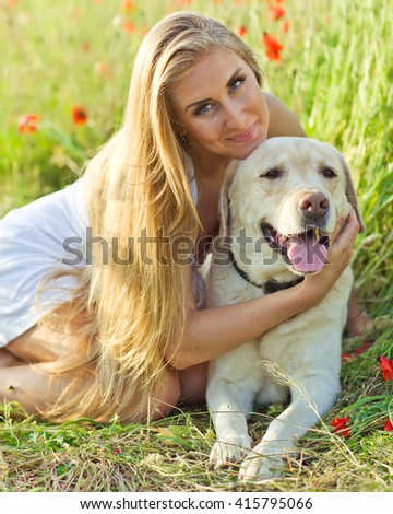 Similar – Pretty blond woman with her two dogs