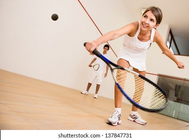 Beautiful woman playing a match of squash