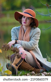 Beautiful Woman Portrait. Attractive Woman Sitting By The Lake. Fashion Shoot. Selective Focus
